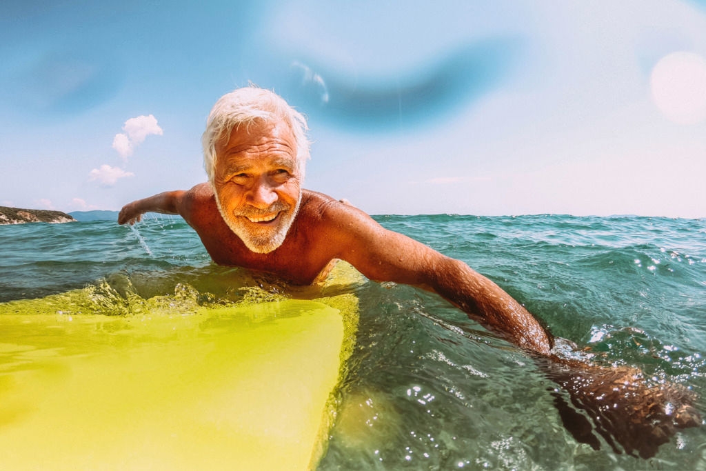 Photo of a senior man surfing in the sea